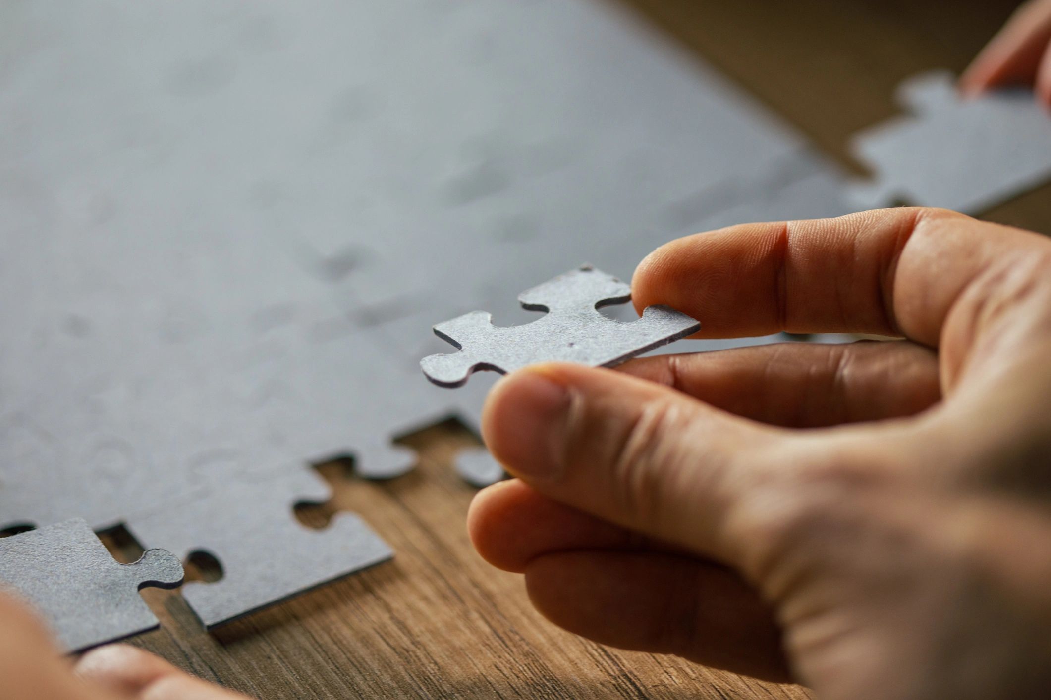 Man putting a puzzle piece into place