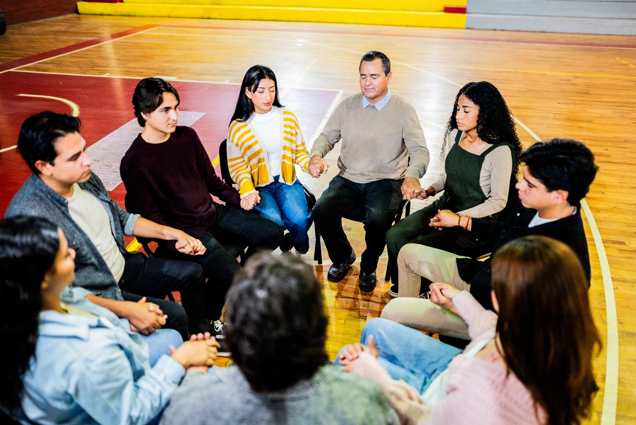 Man praying with a small group