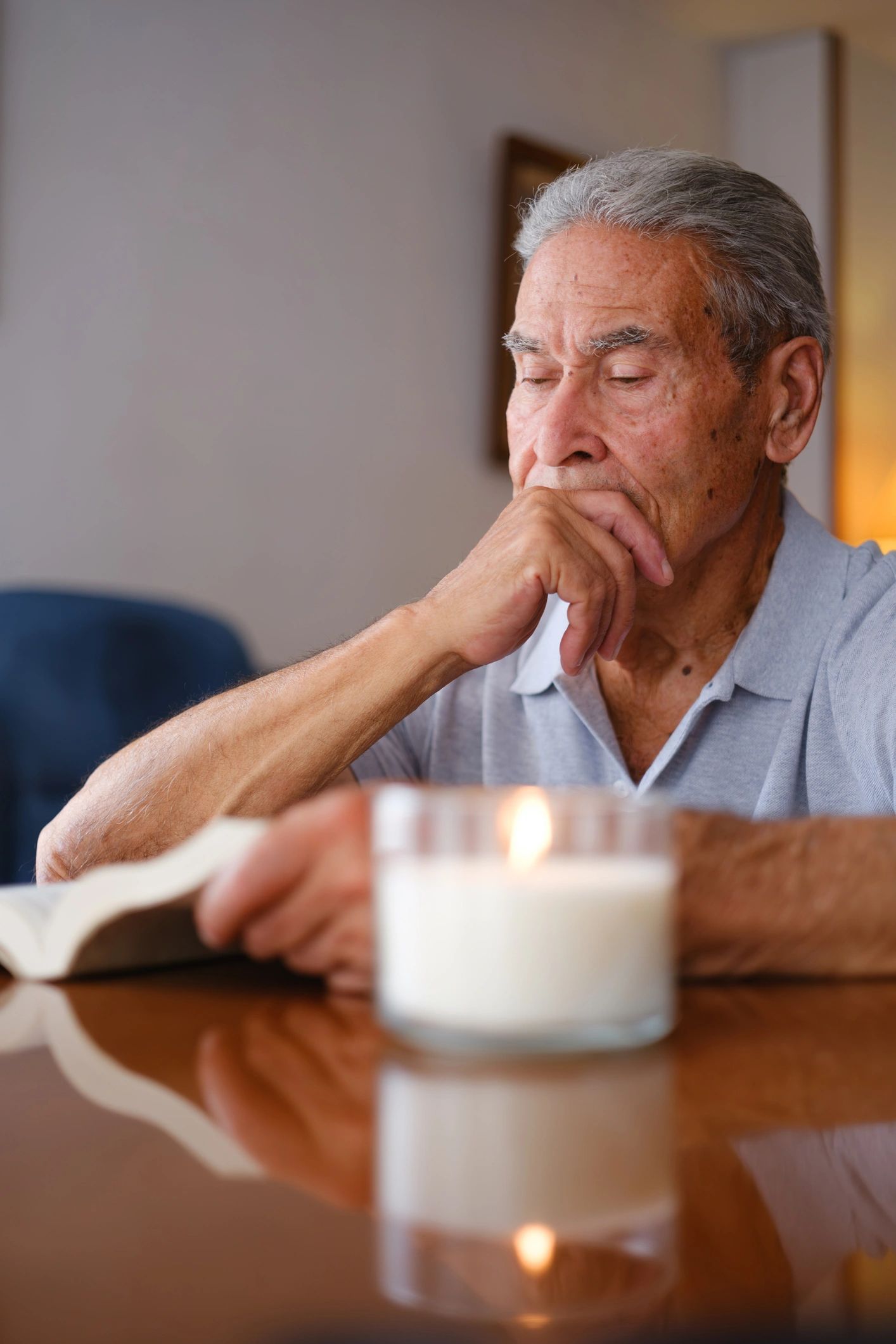 Man reading thoughtfully in a living room
